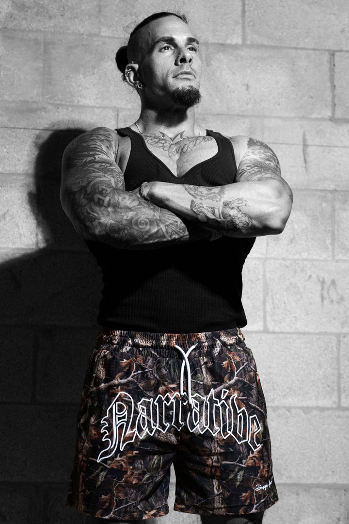Signature Logo 5 inch inseam Shorts RealTree Camo, Model Arms Crossed
