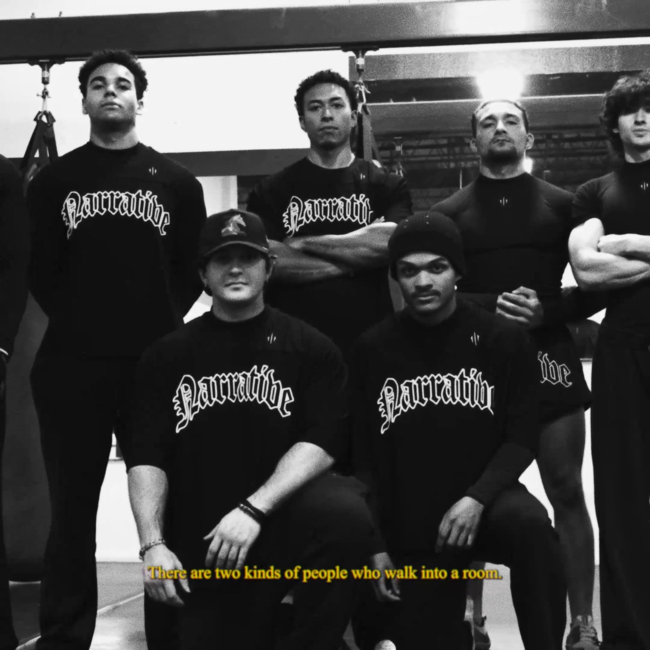 Group of people wearing 'Narrative' shirts with a quote on a black and white photo.